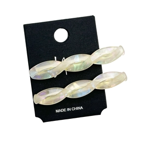 Elegant twisted acetate hair clips with pearlescent finish on black display card