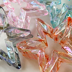 Holographic star shaped hair claw clips in assorted gradient colors for high ponytail styles