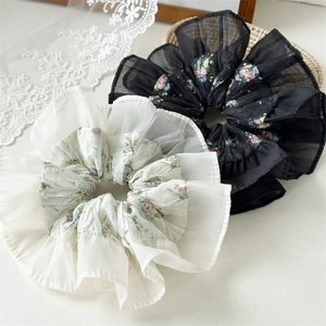 Floral print scrunchies in black and beige with layered ruffles and chiffon texture