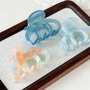 Three acetate pumpkin hair claws in blue and orange marble finish, France handmade quality