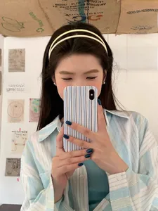 Detail view of double-layer cream acrylic headband worn by model in a Korean style setting