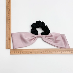 Pink satin bow scrunchie for women with dual-layer fabric and size measurement
