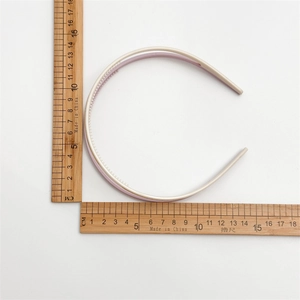 Detailed view of cream-colored double layer acrylic headband with anti-slip teeth