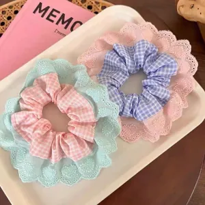 Set of two pastel plaid scrunchies with delicate lace edges in pink and green