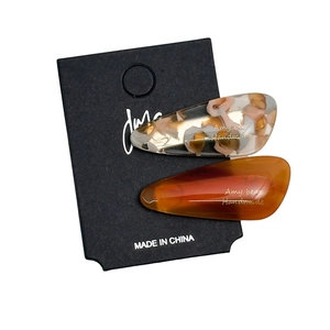 2-pack acetate water drop hair clips in amber and caramel brown on display card