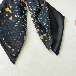 Detailed macro view of the double-layer floral satin fabric and stitching for hair scrunchies