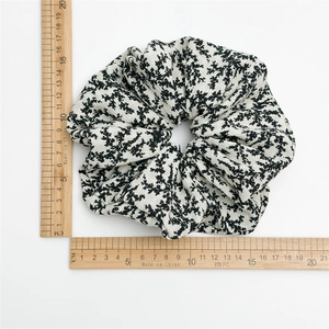 Floral fabric scrunchie with 18cm diameter measurement shown on a white background