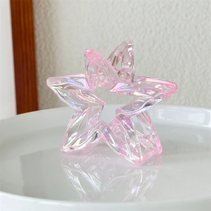 Macro view of laser hollow star hair claw clip with colorful iridescent resin finish