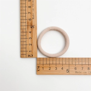 Détail d'un élastique beige sans couture montrant un diamètre de 4,5 cm sur règle