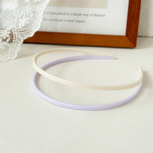 Detailed view of cream and light purple acrylic headbands with non-slip teeth texture