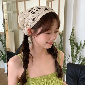 Detailed knit texture of cream white hollow-out floral crochet hair bandana on model