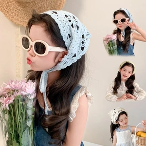 Detailed macro view of hollow crochet flower patterns on soft cotton triangle headscarves