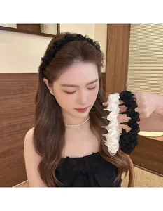 Detailed close-up of pleated mesh headband with delicate pearls in black and beige