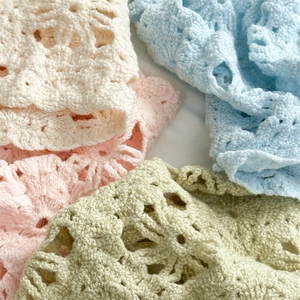 Detailed close-up of hollow crochet floral headbands in four soft pastel colors