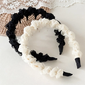 Detail of pleated mesh headbands with pearls featuring anti-slip inner combs and fabric ends