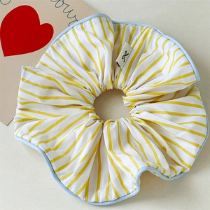 Chic yellow striped oversized fabric scrunchie with blue piping and bow logo tag