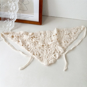 Detailed shot of beige crochet floral headscarf with hollow knit pattern and ties