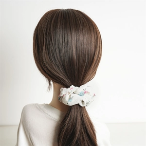 Floral chiffon scrunchie in cream white with pink flower pattern on a ponytail