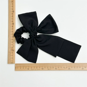 Large black oversized bow hair scrunchie with long ribbons and measuring rulers