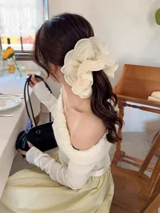 Close-up of layered cream lace scrunchie with ruffle detail on female ponytail