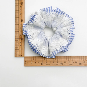 Blue and white striped scrunchie with lace trim, measuring 12cm in diameter
