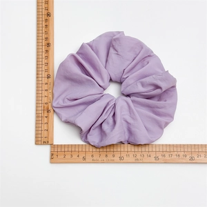 Oversized purple pleated sponge scrunchie for women, measuring 13.5cm on white background