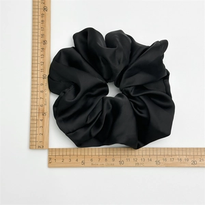 Oversized black satin scrunchie with high elasticity measuring 20cm for voluminous hair