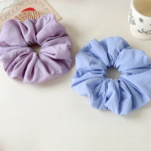 Detail of purple and blue pleated scrunchies with soft cotton fabric texture