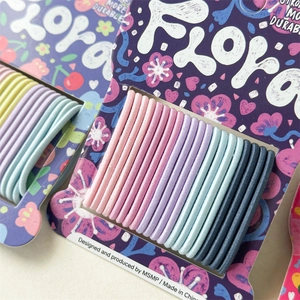 Detail of multi-colored high-elastic seamless hair ties set on floral cardboard cards