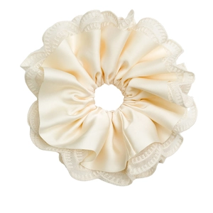 Elegant cream satin scrunchie with layered lace edges and a soft pleated texture