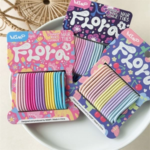 Set of colorful seamless elastic hair ties in pastel tones on a decorative plate