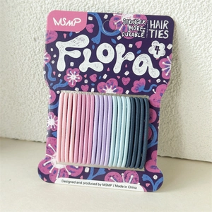 Detail of candy-colored seamless elastic hair ties on floral display card set