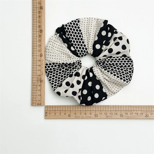 Large black and white polka dot scrunchie with mixed geometric patterns and 15cm diameter