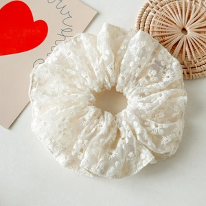 Chouchou élégant en dentelle blanche avec broderie marguerite sur fond minimaliste