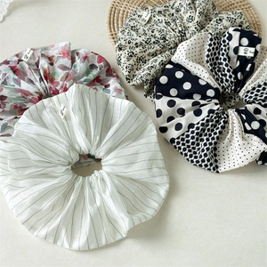 Detailed set of four polka dot and floral scrunchies with elegant woven labels