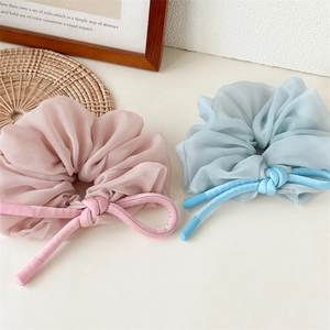 Detail of blue and lavender organza hair scrunchies with satin ribbons on a desk