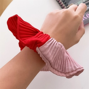 Minimalist red and pink pleated scrunchie with two-tone texture shown on wrist
