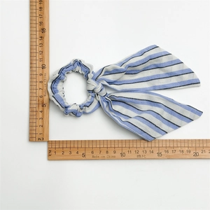 Measurement of blue and white striped scrunchie with long bow tail showing 18cm length