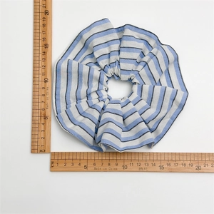 Blue and white striped scrunchie made of pleated fabric, 14.5cm diameter with size ruler