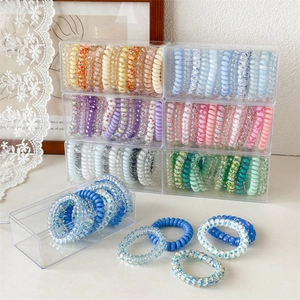 Variety set of colorful phone cord hair ties in a clear acrylic storage box case