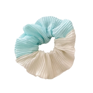 Pleated dual-color scrunchie in light blue and beige chiffon for summer hair styling