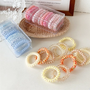 Detailed close-up of colorful spiral hair ties in various patterns and floral prints