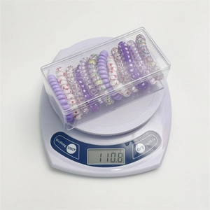 Detailed view of spiral hair ties set weighing 110.8g with clear storage box case