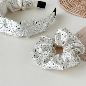 Elegant cream satin headband and scrunchie set with shimmering rhinestones in 45-degree view