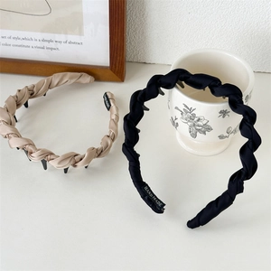 Detail showing the non-slip comb teeth and handmade labels on woven headbands