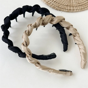 Detail of woven satin headbands in black and champagne gold with non-slip inner teeth