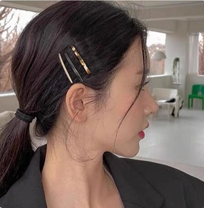 Three-piece set of acetate side hair clips in beige, black, and tortoise shell on a model