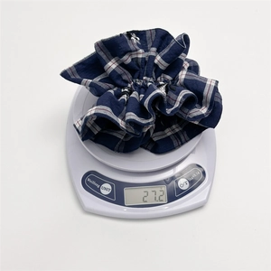 Blue and white checkered oversized hair scrunchie with embroidery on digital scale