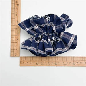 Blue and white checkered fabric scrunchie with floral embroidery and natural ruffles