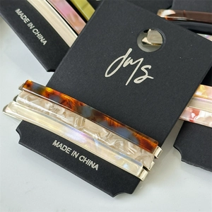 Set of three acetate hair clips with tortoiseshell and marble texture on black card
